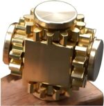 Gold mechanical gears sculpture on wooden base