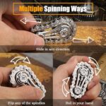 Hand holding chain fidget toy, multiple spinning ways.