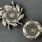 Metal fidget spinners on gray surface